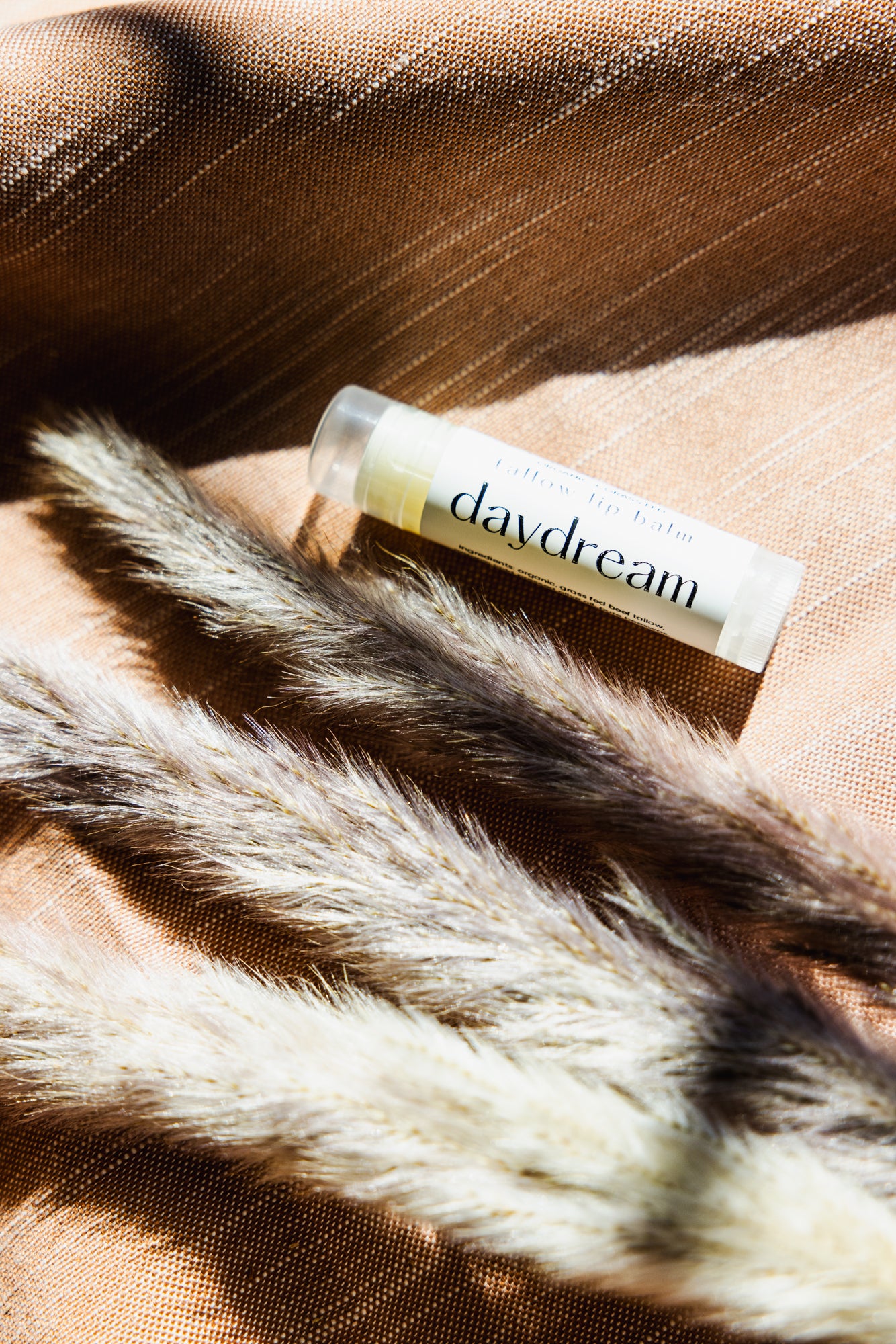 Alpine Gold Tallow Based lip balm in DAYDREAM. With a calming chamomile scent to add serenity to any day. All natural, non-toxic, chemical free - made from certified organic and grass fed tallow. Hydrating, vitamin packed, anti-aging.